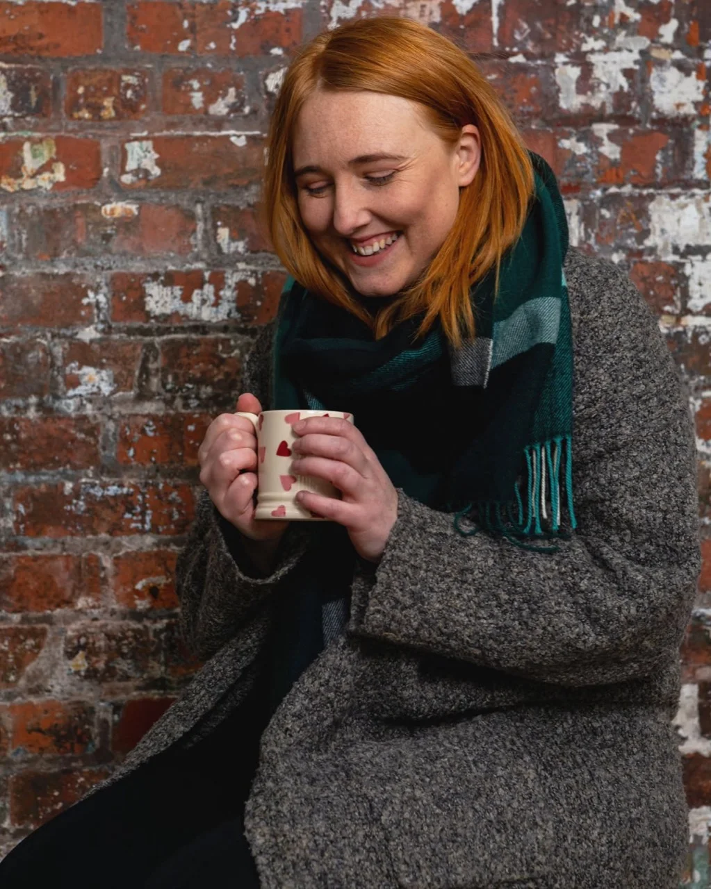 Laura smiling with a cup of tea